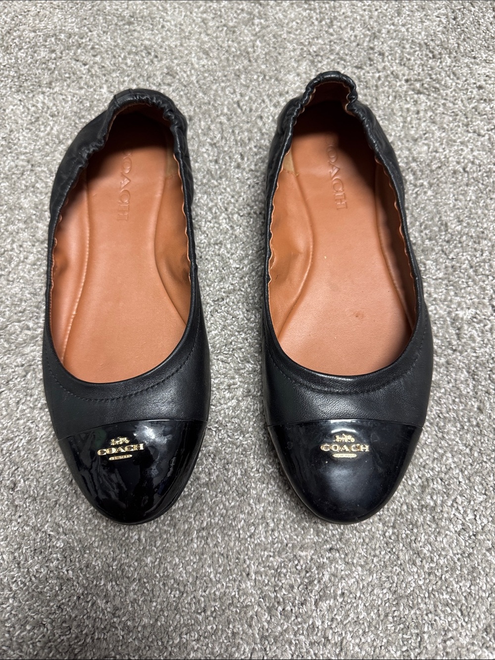 Coach Black Leather Ballet Flats with Glossy Cap Toe and Gold Logo